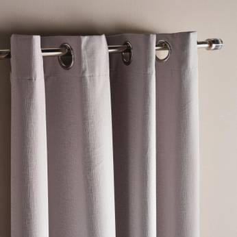 Gray curtains with metal rings on a neutral background