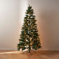 Decorated Christmas tree with lights on a plain background