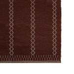 Brown rug with geometric pattern on a white background