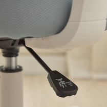 Ergonomic chair armrest with control switch on a blurred office chair background