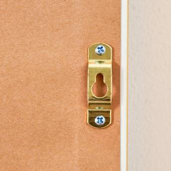 Close-up of a gold door handle on a wooden door