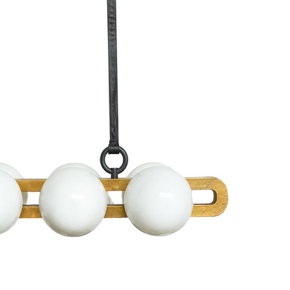 Close-up of a pendant light with white glass shades and wooden fixture on a white background
