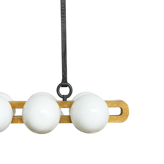 Close-up of a pendant light with white glass shades and wooden fixture on a white background