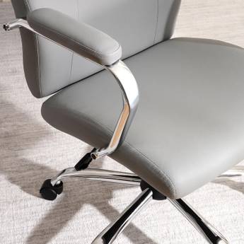 Gray office chair with chrome accents on a light wooden floor.