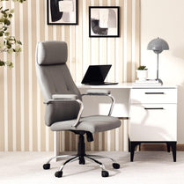 Gray office chair in a modern office setting with a desk and decor.