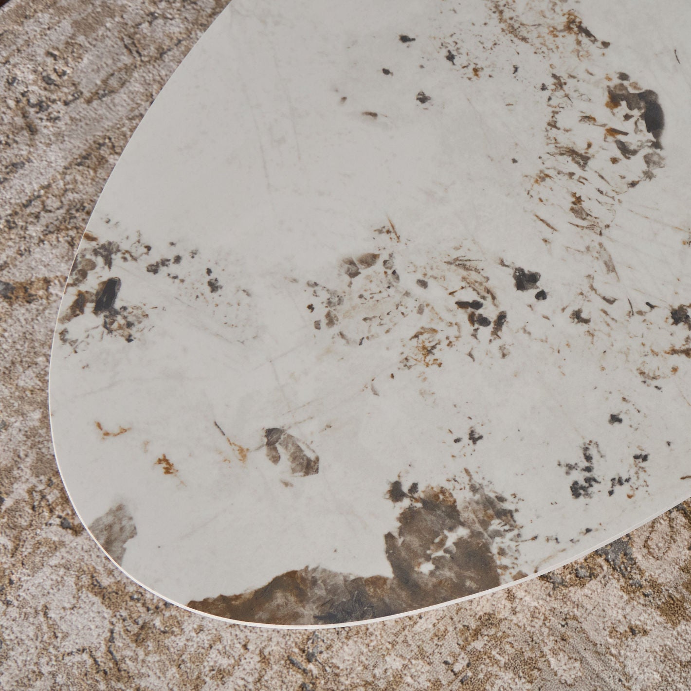 Round mirror with a textured surface on a stone-like background