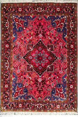 Decorative red and blue patterned rug with intricate designs on a white background- Luxury Rug Handmade Oriental Rug | Handmade in Afghanistan – Bergamot | Luxury Living Room Décor