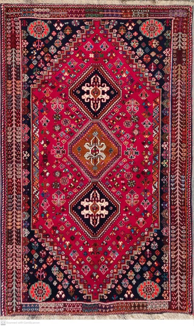 Decorative red rug with intricate patterns on a plain background- Luxury Rug Handmade Persian Rug | Handmade in Iran – Shiraz | Luxury Living Room Décor