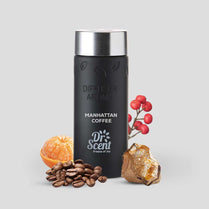 Black coffee diffuser with coffee beans, orange, and red berries on a light gray background