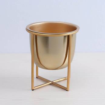 Gold metal planter on a light gray background