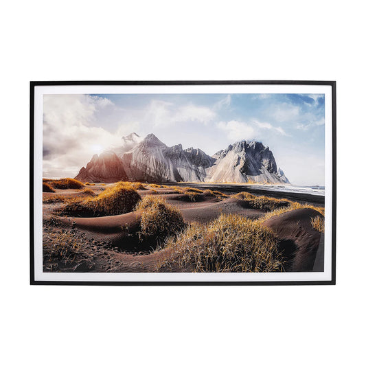 Framed photograph of a mountainous landscape with a beach and sky.