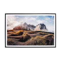 Framed photograph of a mountainous landscape with a beach and sky.