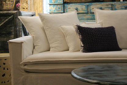 Beige sofa with decorative pillows in a room setting. New York Collection Sofa – Live in the Now | Vella Concept