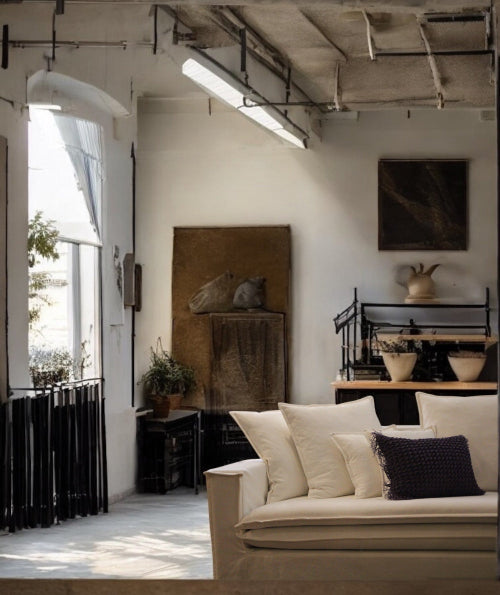 Modern interior with a beige sofa, decorative pillows, and a large window. New York Collection Sofa – Live in the Now | Vella Concept