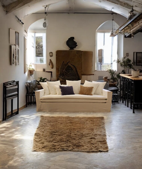 Living room with a beige sofa, wooden coffee table, and decorative items.