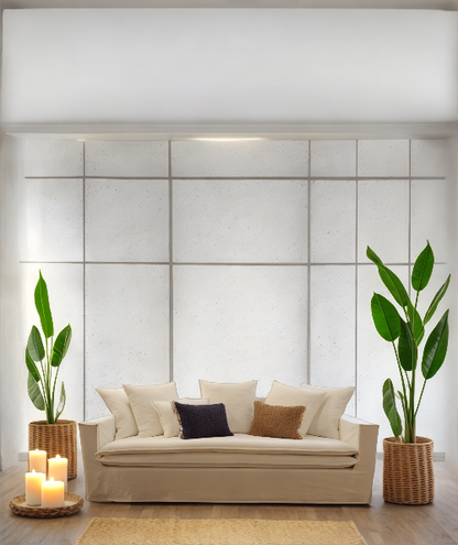 Beige sofa with decorative pillows in a modern living room setting with plants and candles. New York Collection Sofa – Live in the Now | Vella Concept