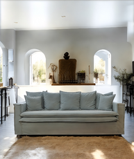 Gray sofa in a modern living room with white walls and decorative items. New York Collection Sofa – Live in the Now | Vella Concept