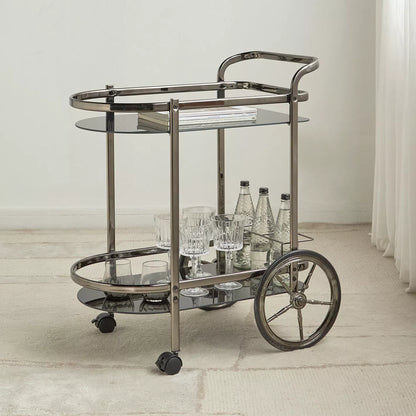 Bar cart with glass shelves and wheels in a minimalistic room.- Notica Serving Trolley - Metal & Glass 81cm