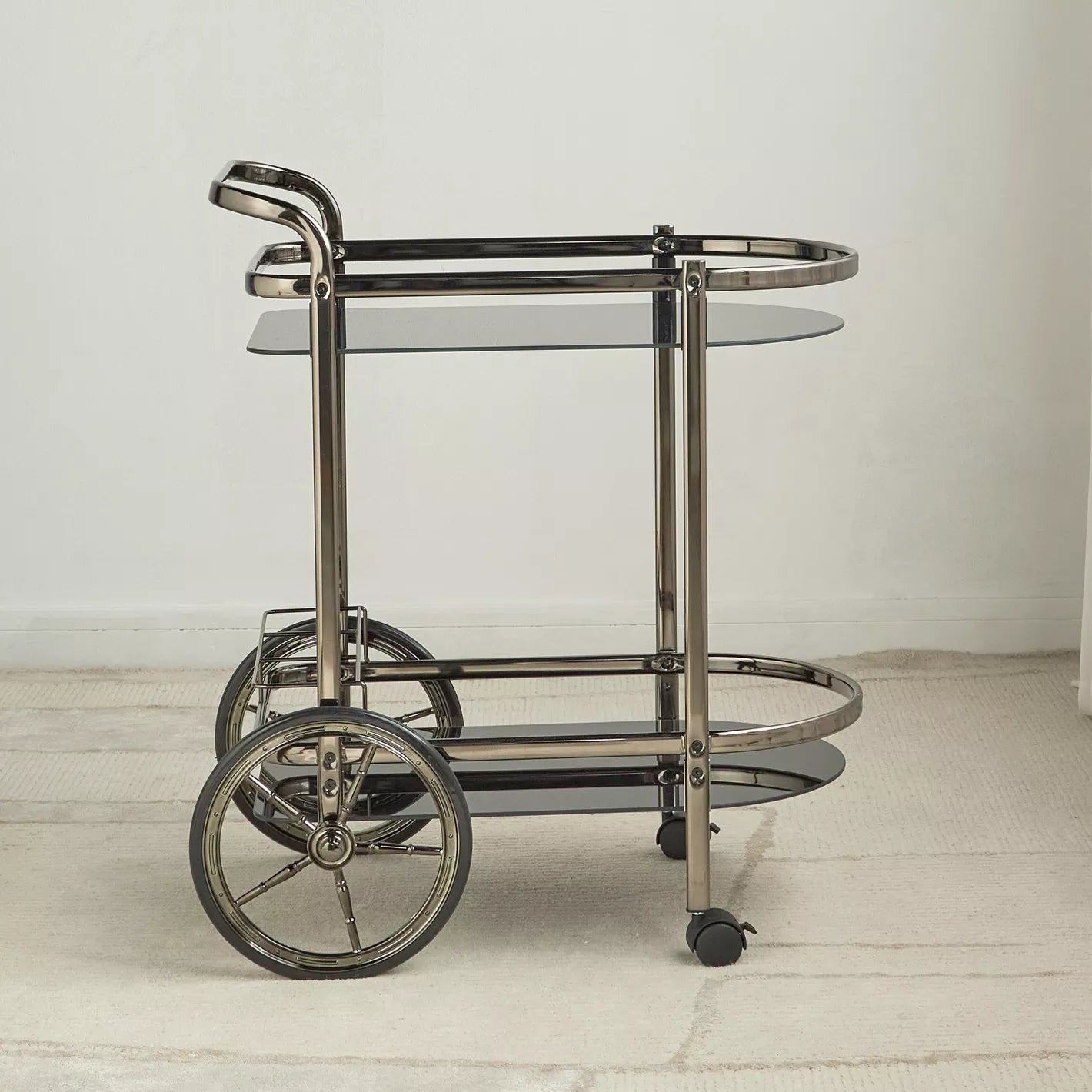 Metallic bar cart with glass shelves on a light wooden floor-  Notica Serving Trolley - Metal & Glass 81cm
