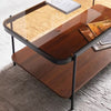 Wooden coffee table with glass top on a gray floor- Nya Coffee Table – Brown Wood Finish