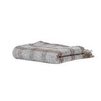 Folded blanket with a striped pattern on a white background