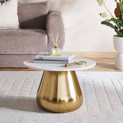 Coffee table with gold base and white top in a living room setting
