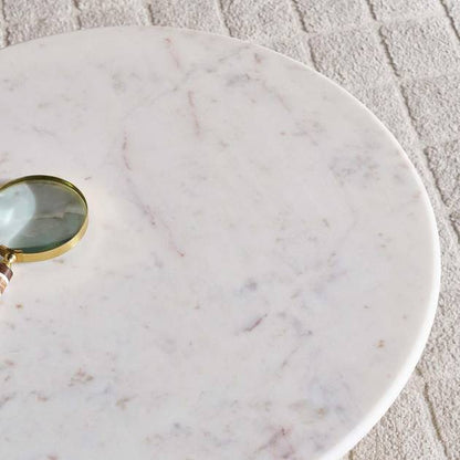 Marble surface with a magnifying glass on a textured floor