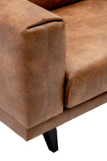 Close-up of a brown leather sofa corner with visible stitching.