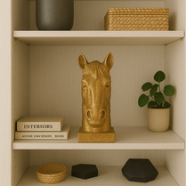 Gold horse head sculpture on a shelf with books and decor items- Regal Gold Horse Head Sculpture – Modern Decorative Accent