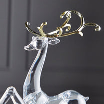 Crystal deer figurine with gold antlers on a dark background