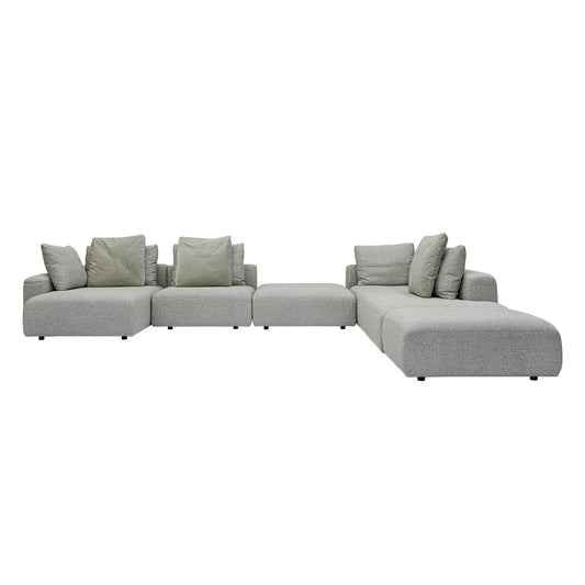 Gray sectional sofa with green cushions on a white background