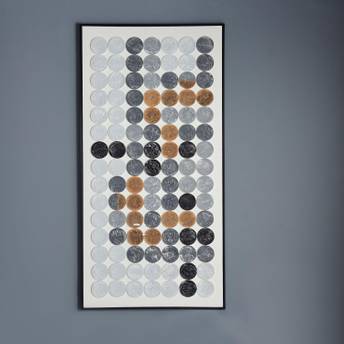 Framed artwork with circular patterns on a gray wall