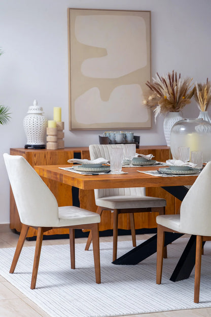 Dining room with wooden table and chairs, abstract art on the wall, and decorative elements.