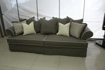 Gray sectional sofa with decorative pillows in a room setting. Roma Collection Sofa – Serene Comfort in a Chaotic World | Vella Concept