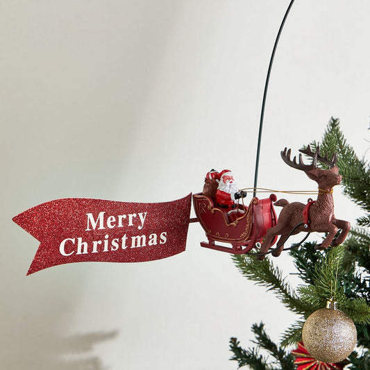 Christmas ornament with Santa in a sleigh and reindeer, featuring a 'Merry Christmas' banner, on a tree.