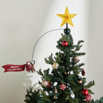 Decorated Christmas tree with a gold star topper and 'Merry Christmas' banner on a plain background