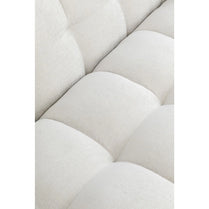 Close-up of a tufted beige fabric with a white background