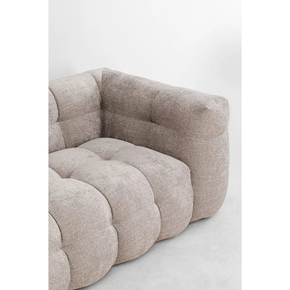 Beige armchair with a textured fabric on a white background