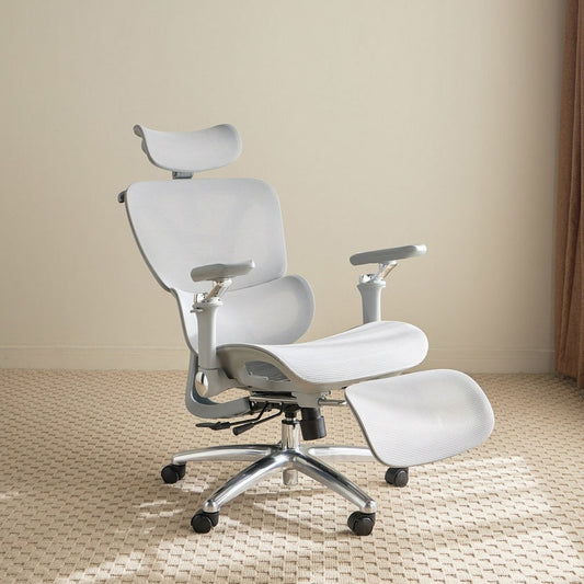 White ergonomic office chair with headrest and footrest on a beige floor.