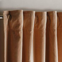 Close-up of brown curtains with a neutral background