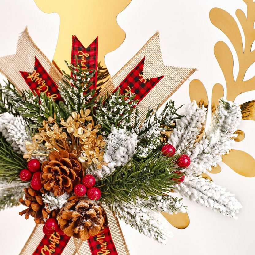 Decorative Christmas wreath with pine cones, berries, and gold leaves on a white background