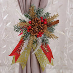 Decorative Christmas bow with pine cones, berries, and ribbons on a curtain.