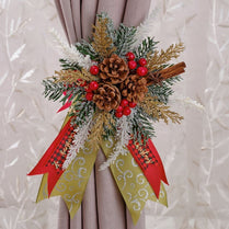 Decorative Christmas bow with pine cones, berries, and ribbons on a curtain.