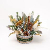 Christmas-themed floral arrangement with decorative elements on a white background