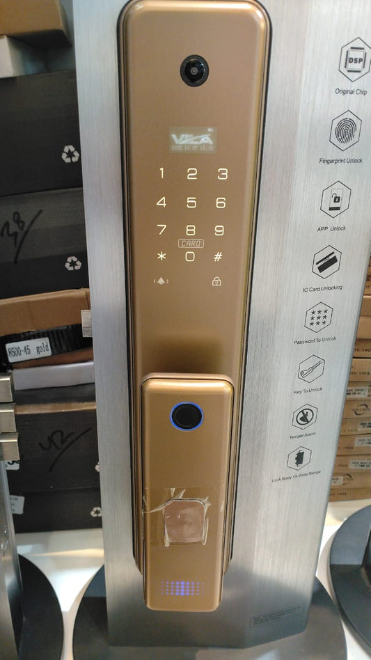 Gold electronic door lock with digital keypad on a metallic surface