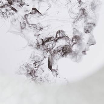 Black smoke or ink swirling on a white background