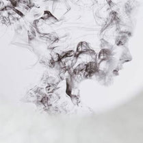 Black smoke or ink swirling on a white background
