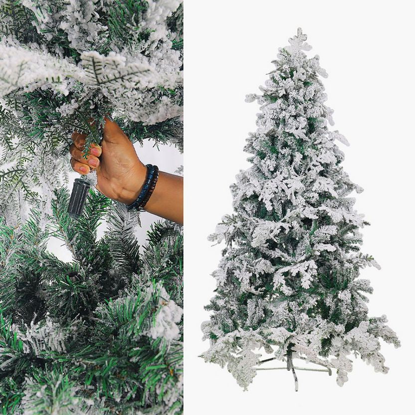 Frosty artificial Christmas tree with hand adjusting a branch on a white background