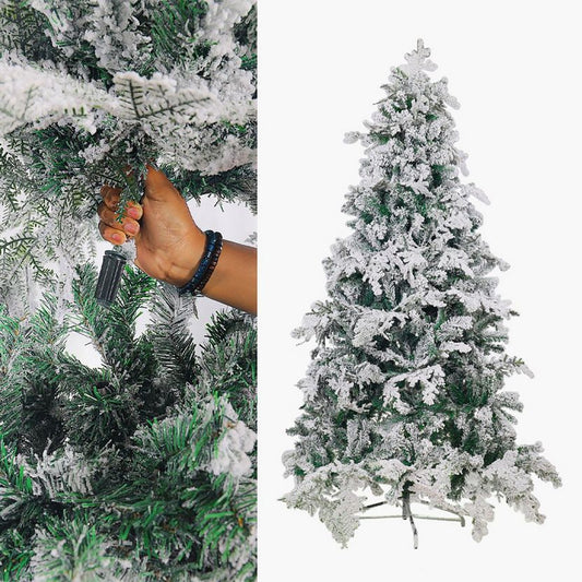 Frosty artificial Christmas tree with hand adjusting a branch on a white background