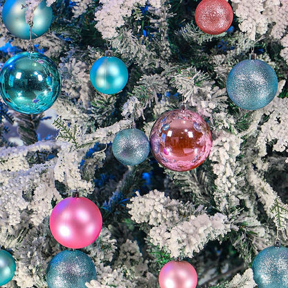 Decorative Christmas tree with colorful ornaments on a snowy branch.
